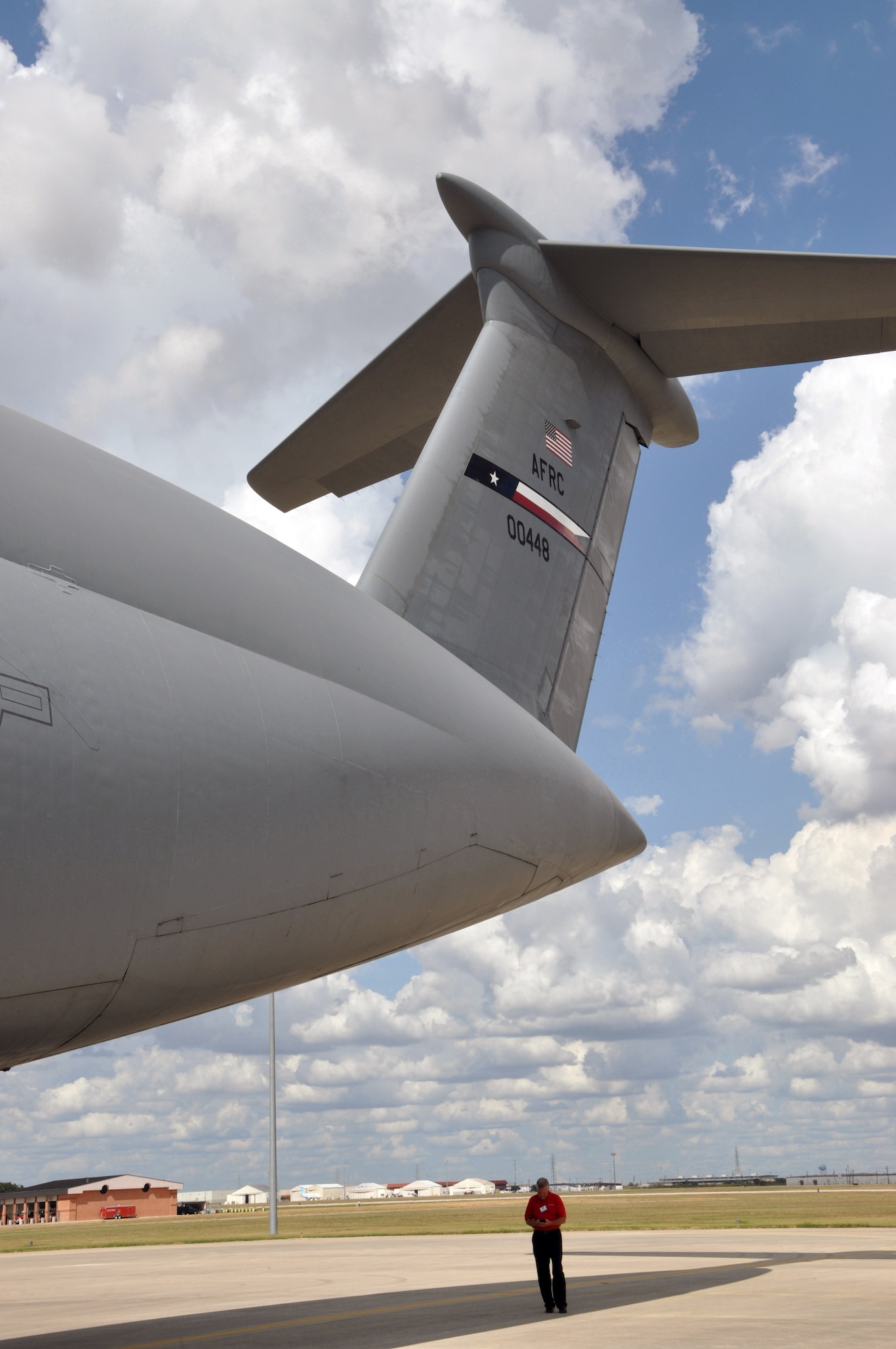 Showcasing the size of the Air Force's largest airlifter, a civic leader walks beneath the tail of a C-5 Galaxy during the 2015 307th Bomb Wing Civic Leader Tour at Joint Base San Antonio, Texas, Sept. 1-2, 2015.  The tour gave 29 Louisiana civic leaders the opportunity to get a closer look at the mission of the Air Force Reserve during the two-day trip from Barksdale to Joint Base San Antonio and Dyess Air Force Base in Texas. The trip included a refueling of the B-52 Stratofortress and B-1 Lancer; a C-5 Galaxy and B-1 static tour; a visit to the Center for the Intrepid for wounded warriors; and networking with other local community leaders. (U.S. Air Force photo by Master Sgt. Mary Hinson/Released)