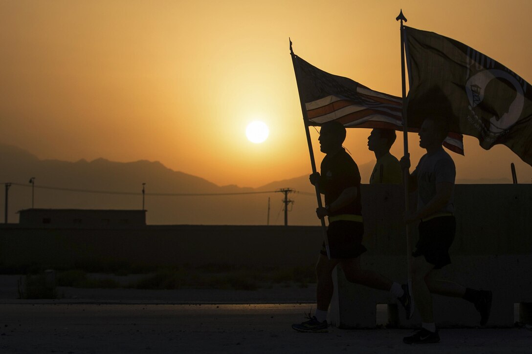 U.S. service members participate in a run to honor prisoners of war and those missing in action on Bagram Airfield, Afghanistan, Sept. 4, 2015. For 24 straight hours, service members kept the POW/MIA flag in constant motion to focus on American prisoners of war and those missing. U.S. Air Force photo by Tech. Sgt. Joseph Swafford