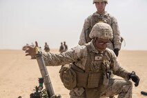 KUWAIT (Aug. 26, 2015) U.S. Marine Lance Cpl. Maurice Gardner fires a mortar round from an M224A1 60 mm mortar system during call for fire training. Gardner is an assistant gunner with Kilo Company, Battalion Landing Team 3rd Battalion, 1st Marine Regiment, 15th Marine Expeditionary Unit. During the training squad leaders sharpened their call-for-fire skills with mortar men. Elements of the 15th MEU are ashore in Kuwait for sustainment training to maintain and enhance the skills they developed during their pre-deployment training period. The 15th MEU is embarked with the Essex Amphibious Ready Group and deployed to maintain regional security in the U.S. 5th Fleet area of operations. (U.S. Marine Corps photo by Sgt. Emmanuel Ramos/Released)