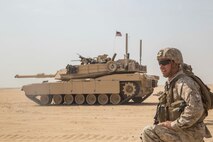 KUWAIT (Aug. 25, 2015) U.S. Marine Cpl. Nicholas Skidmore maneuvers his squad down the battlefield during mechanized squad attack training. Skidmore is a squad leader with Kilo Company, Battalion Landing Team 3rd Battalion, 1st Marine Regiment, 15th Marine Expeditionary Unit. The training focused on the squad’s ability to work as a cohesive unit while using AAV-7 Amphibious Assault Vehicles and M1A1 Abrams tanks to effectively eliminate enemy targets. Elements of the 15th MEU are ashore in Kuwait for sustainment training to maintain and enhance the skills they developed during their pre-deployment training period.  The 15th MEU is embarked with the Essex Amphibious Ready Group and deployed to maintain regional security in the U.S. 5th Fleet area of operations. (U.S. Marine Corps photo by Sgt. Emmanuel Ramos/Released)