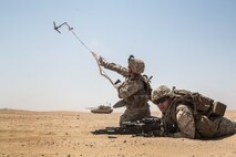 KUWAIT (Aug. 24, 2015) U.S. Marines Lance Cpl. Malachi Askland (left) and Cpl. Matthew Kobylarz clear a safe lane for their squad during mechanized squad attack training. Askland is an assualtman and Kobylarz is an assault team leader, both with Kilo Company, Battalion Landing Team 3rd Battalion, 1st Marine Regiment, 15th Marine Expeditionary Unit (MEU). The training focused on the squad’s ability to effectively utilize AAV-7 Amphibious Assault Vehicles, and M1A1 Abrams tanks to close with and destroy enemy targets. Elements of the 15th MEU are ashore in Kuwait for sustainment training to maintain and enhance the skills they developed during their pre-deployment training period. The 15th MEU is embarked with the Essex Amphibious Ready Group and deployed to maintain regional security in the U.S. 5th Fleet area of operations. (U.S. Marine Corps photo by Sgt. Emmanuel Ramos/Released)