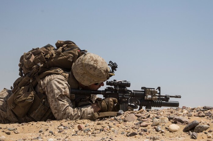 KUWAIT (Aug. 24, 2015) U.S. Marine Cpl. Matthew Kobylarz engages targets during mechanized squad attack training. Kobylarz is an assault team leader with Kilo Company, Battalion Landing Team 3rd Battalion, 1st Marine Regiment, 15th Marine Expeditionary Unit (MEU). The training focused on the squad’s ability to effectively utilize AAV-7 Amphibious Assault Vehicles and M1A1 Abrams tanks to close with and destroy enemy targets. Elements of the 15th MEU are ashore in Kuwait for sustainment training to maintain and enhance the skills they developed during their pre-deployment training period.  The 15th MEU is embarked with the Essex Amphibious Ready Group and deployed to maintain regional security in the U.S. 5th Fleet area of operations. (U.S. Marine Corps photo by Sgt. Emmanuel Ramos/Released)