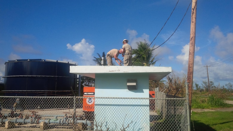 Soldiers from the U.S. Army’s 249th Engineer Battalion Delta Company, U.S. Army Corps of Engineers, connect emergency generator powerlines to a water pump substation on Saipan as part of the federal response to Typhoon Soudelor. 