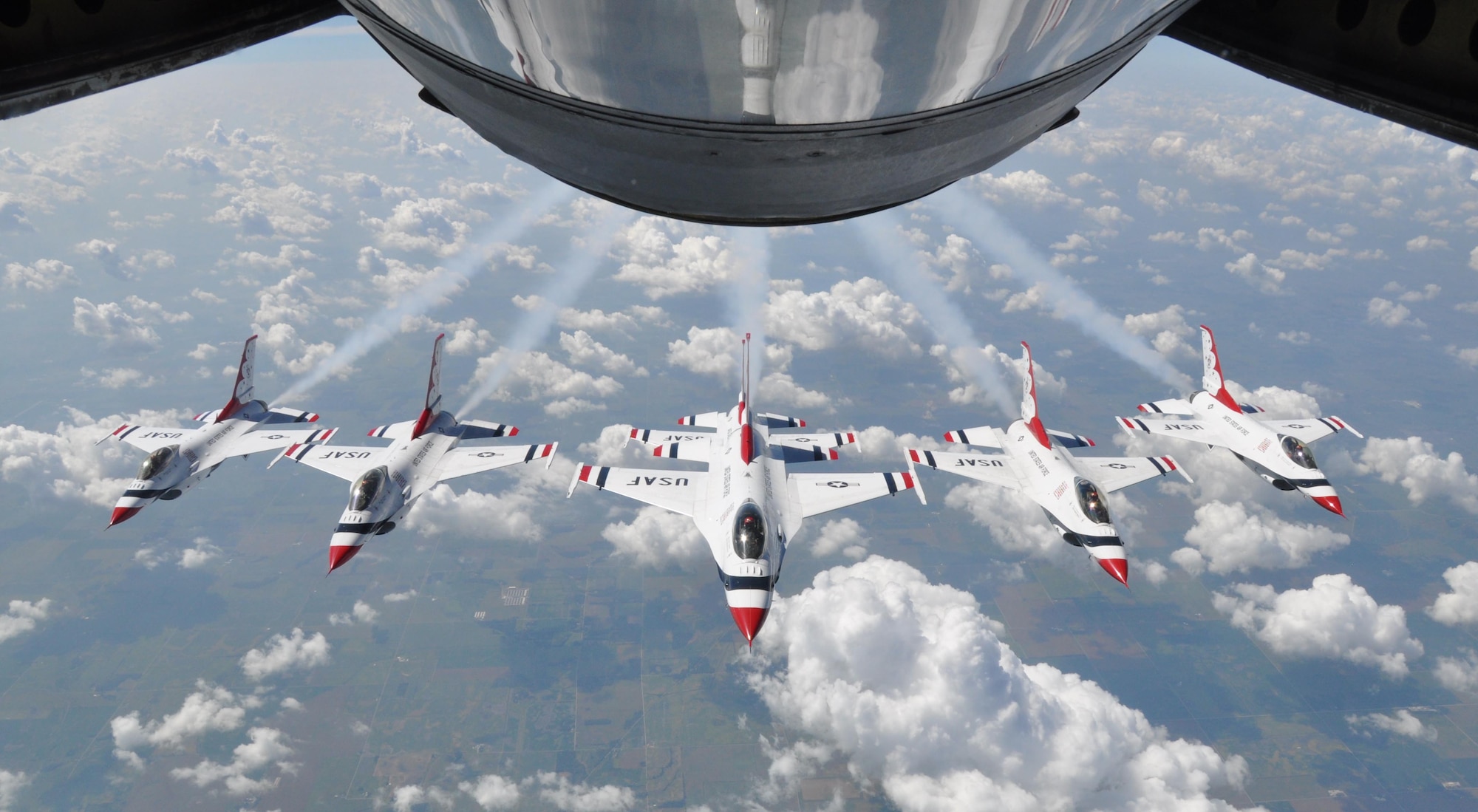 The U. S. Air Force Thunderbirds Air Demonstration Squadron, fly their F-16 Fighting Falcons in formation near the refueling boom of a KC-135 Stratotanker from McConnell Air Force Base, Kan., Sept. 3, 2015.  The KC-135 provided cross-country air refueling support for the Thunderbirds.  The squadron was on their way to the Cleveland National Air Show in Cleveland, Ohio, Sept. 5-7.  The squadron performs 75 demonstrations each year and has never canceled a demonstration due to a maintenance difficulty.  (U.S. Air Force photo by Tech. Sgt. Abigail Klein)