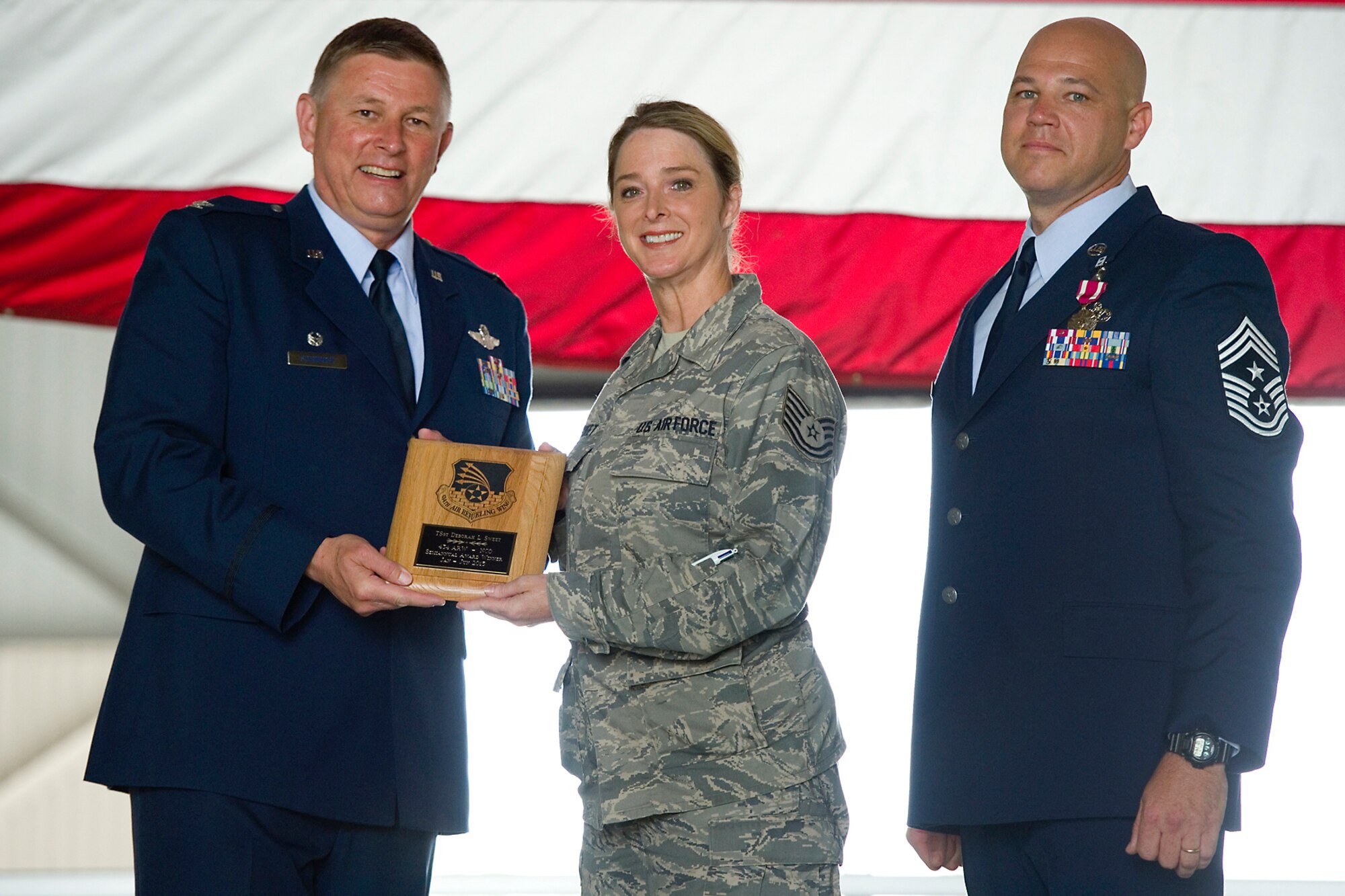 Col. Doug Schwartz, 434th Air Refueling Wing commander, left, presents Tech. Sgt. Deborah Sweet, 434th Maintenance Group education and training specialist, with a plaque after she was named top 434th ARW noncommissioned officer for the first half of 2015 during a commander's call at Grissom Air Reserve Base, Ind., Aug. 9, 2015. Twice a year Grissom recognizes the best of the best with this award program. (U.S. Air Force photo/Senior Airman Jami Lancette)