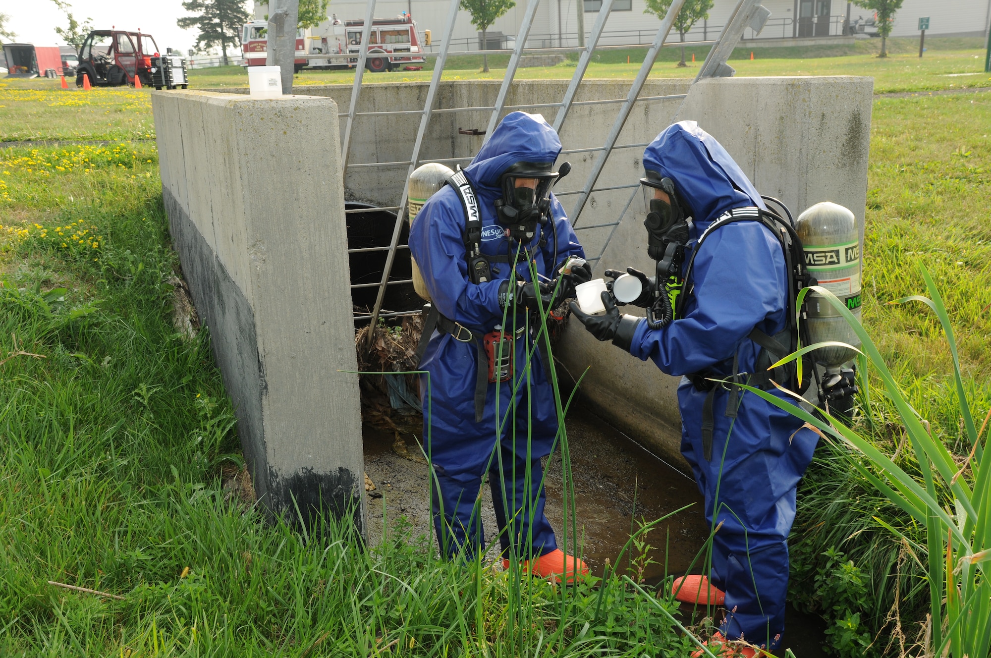 Members of the 914th Mission Support Group Fire Emergency Services inspect a water sample during a hazardous material and confined space exercise at the Niagara Falls Air Reserve Station on Sept. 3, 2015. The exercise showcased the capabilities and preparedness of the base’s fire department. (U.S. Air Force photo by Staff Sgt. Matthew Burke)