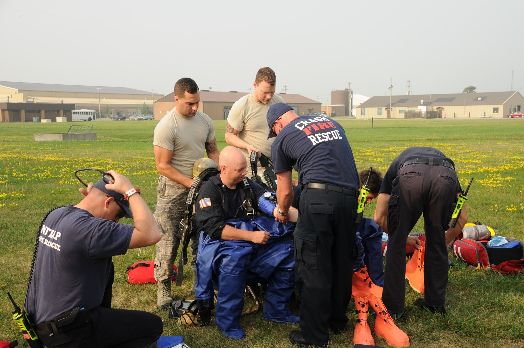 Members of the 914th Mission Support Group Fire Emergency Services check the vitals of personnel before they don protective suits during a hazardous material and confined space exercise at the Niagara Falls Air Reserve Station on Sept. 3, 2015. The exercise showcased the capabilities and preparedness of the base’s fire department. (U.S. Air Force photo by Staff Sgt. Matthew Burke)