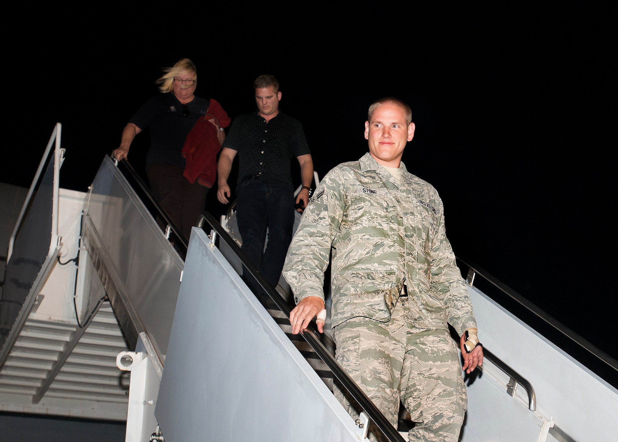Airman 1st Class Spencer Stone, the Airman who helped foil a terrorist attack on a train in France Aug. 21, arrives at Travis Air Force Base, California Sept. 3. Stone was greeted by hundreds of Airmen and their families including Col. Joel Jackson, 60th Air Mobility Wing commander and Chief Master Sgt. Alan Boling, 60th AMW Command Chief.  He will receive continued medical treatment for his injuries at David Grant USAF Medical Center. (U.S. Air Force photo/T.C. Perkins)
