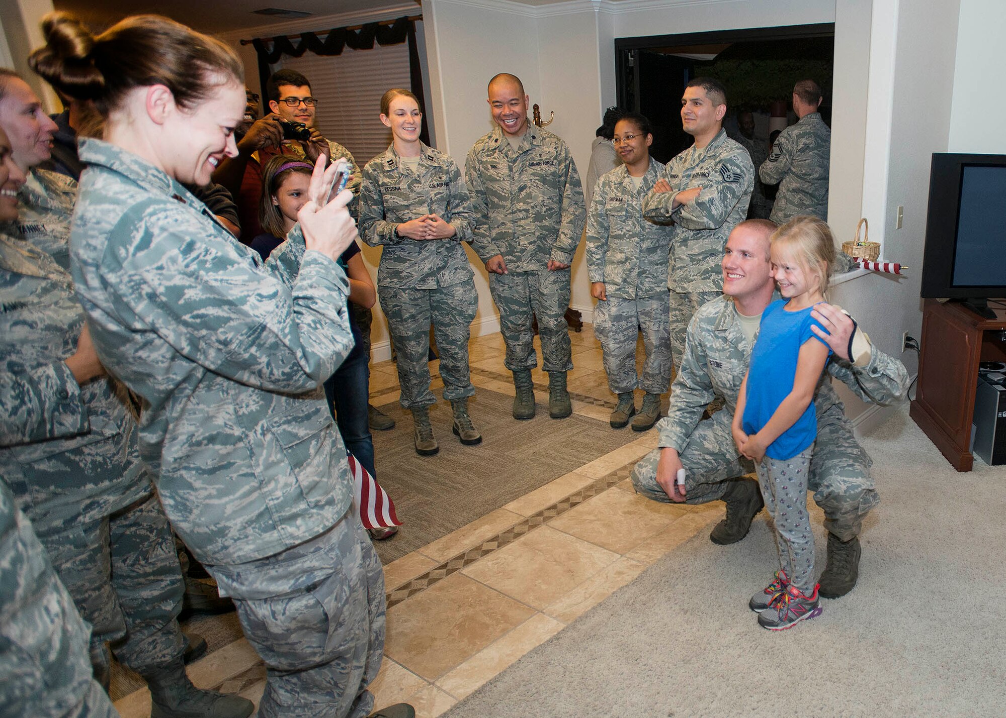 Airman 1st Class Spencer Stone, the Airman who helped foil a terrorist attack on a train in France Aug. 21, poses for photos after arriving at Travis Air Force Base, California Sept. 3. Stone was greeted by hundreds of Airmen and their families including Col. Joel Jackson, 60th Air Mobility Wing commander and Chief Master Sgt. Alan Boling, 60th AMW Command Chief. He will receive continued medical treatment for his injuries at David Grant USAF Medical Center. (U.S. Air Force photo/T.C. Perkins) 
