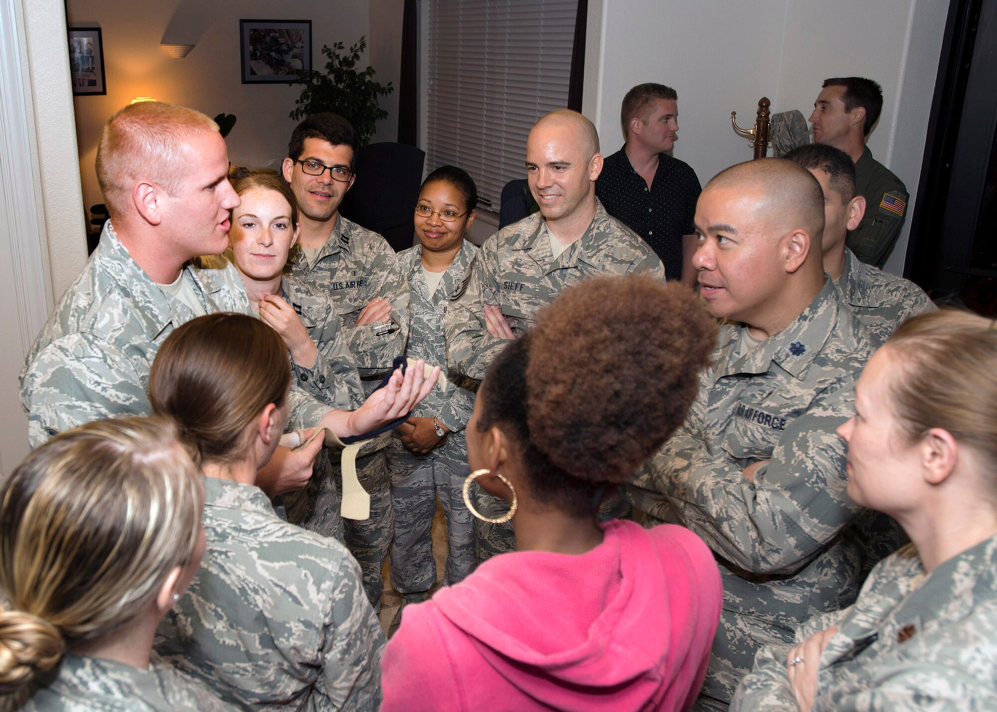 Airman 1st Class Spencer Stone, the Airman who helped foil a terrorist attack on a train in France Aug. 21, speaks with members of Travis Air Force Base, California Sept. 3. Stone was greeted by hundreds of Airmen and their families after arriving at the base including Col. Joel Jackson, 60th Air Mobility Wing commander and Chief Master Sgt. Alan Boling, 60th AMW Command Chief.  He will receive continued medical treatment for his injuries at David Grant USAF Medical Center. (U.S. Air Force photo/T.C. Perkins)