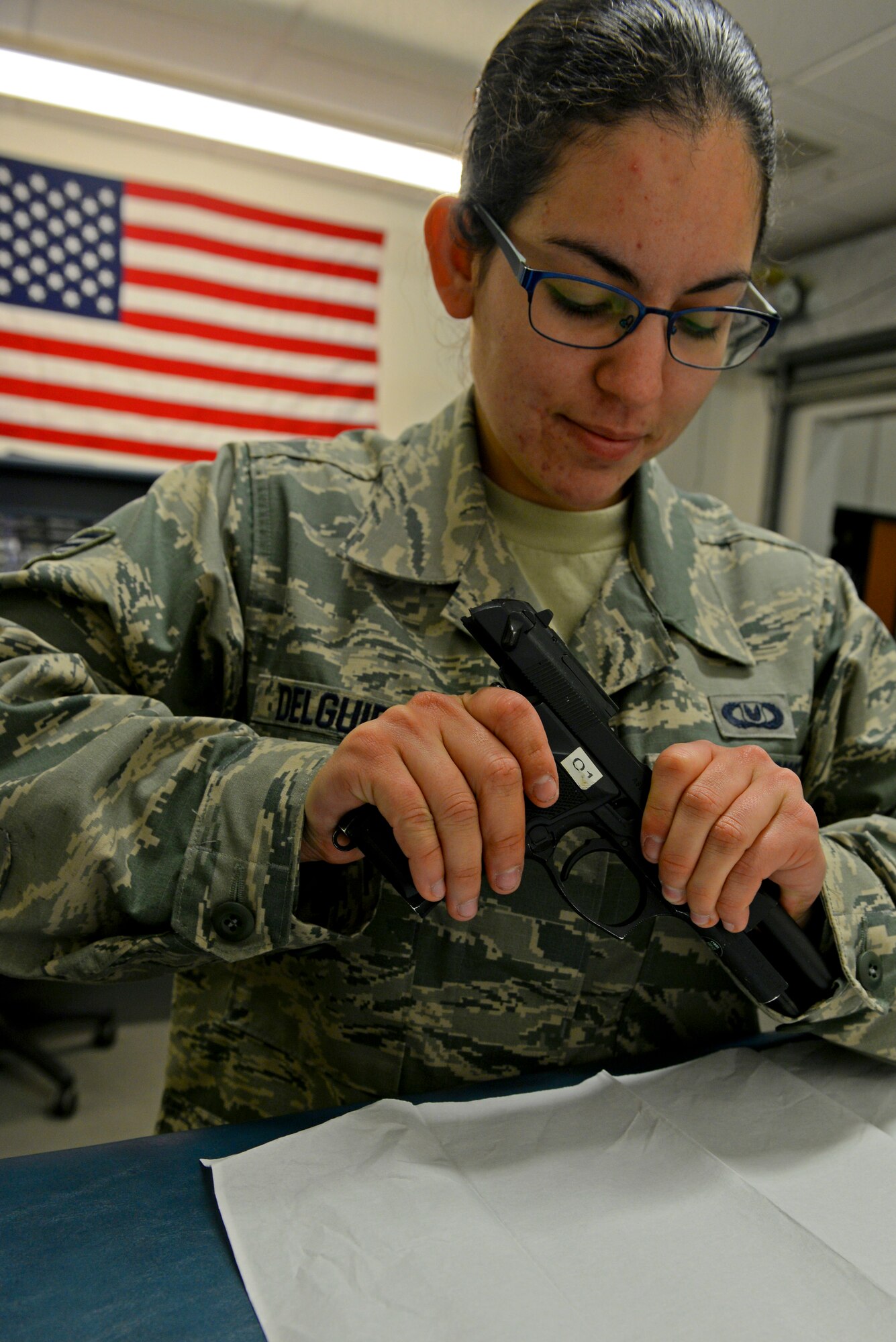 U.S. Air Force Senior Airman Alexandria Delguidice, 100th Operations Support Squadron Aircraft Flight Equipment journeyman, inspects the chamber of an M-9 pistol for ammunition Sept. 3, 2015, on RAF Mildenhall, England. Once the chamber and the magazine well are inspected for munitions, the pistol can be disassembled for cleaning. The aircraft flight equipment section issues firearms to aircrew for missions over hostile areas. (U.S. Air Force photo by Staff Sgt. Micaiah Anthony/Released) 