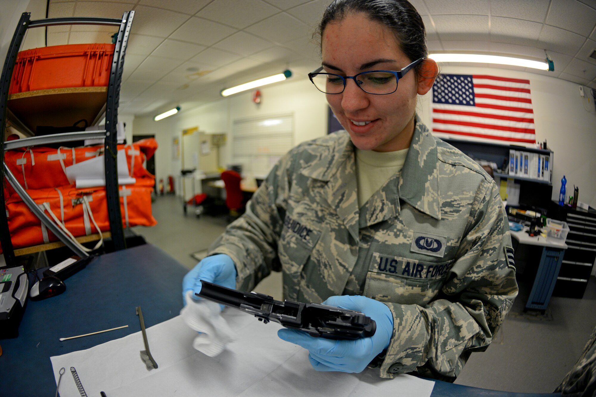 U.S. Air Force Senior Airman Alexandria Delguidice, 100th Operations Support Squadron Aircraft Flight Equipment journeyman, cleans an M-9 pistol Sept. 3, 2015, on RAF Mildenhall, England. Once the weapon is cleaned it must be inspected for cracks, dips, defects and scratches to prevent any malfunctions and maintain serviceability. (U.S. Air Force photo by Staff Sgt. Micaiah Anthony/Released)