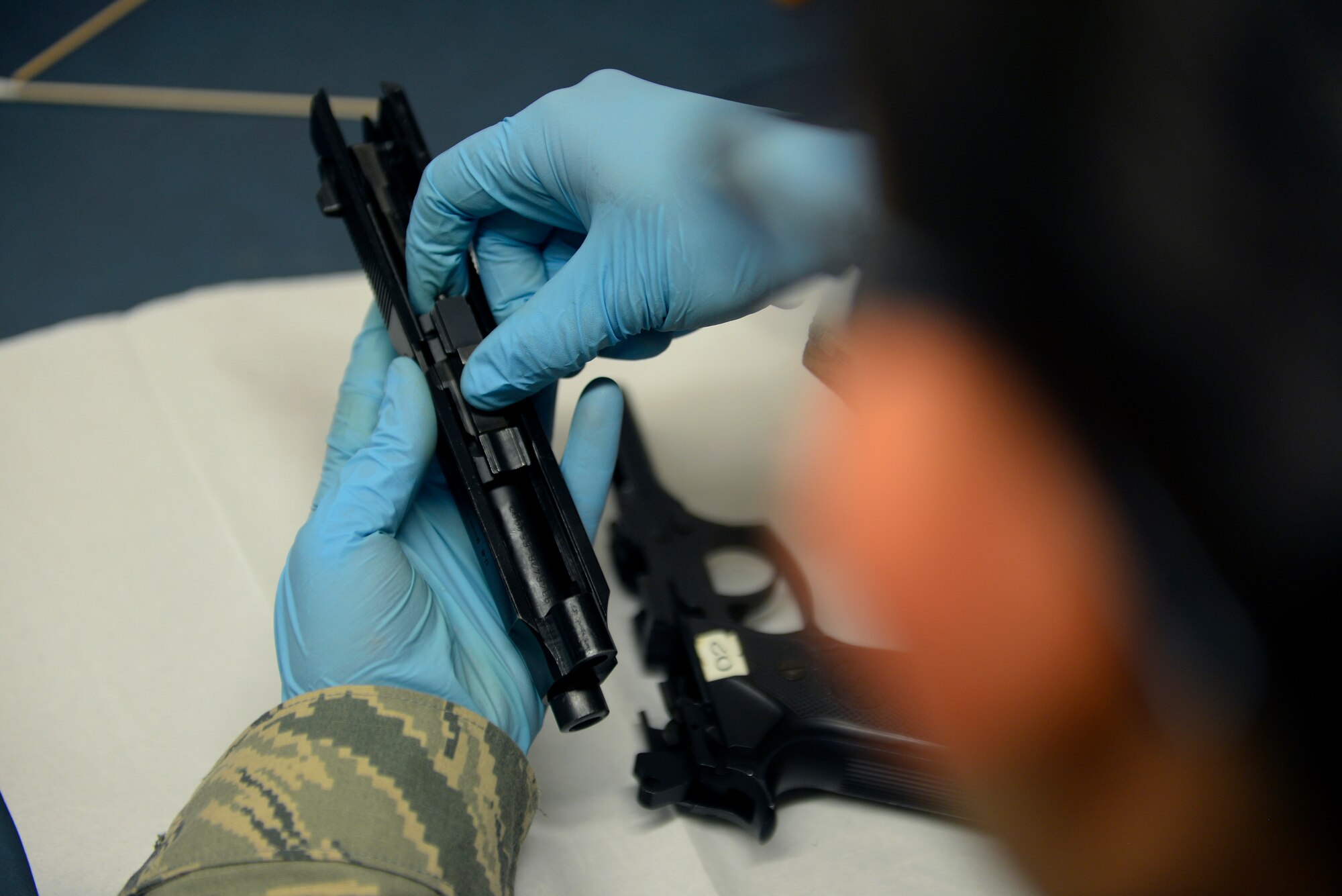 U.S. Air Force Senior Airman Alexandria Delguidice, 100th Operations Support Squadron Aircraft Flight Equipment journeyman, reassembles an M-9 pistol Sept. 3, 2015, on RAF Mildenhall, England. The firearms were disassembled, cleaned and inspected as a part of their 90-day service inspection. If defects are found the weapon must be switched out with the base armory. (U.S. Air Force photo by Staff Sgt. Micaiah Anthony/Released)