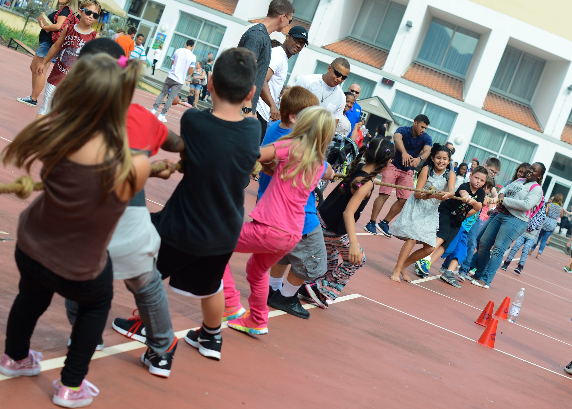Children engage in a tug-of-war competition during the Back-2-School Bash, Sept. 3, 2015, at Aviano Air Base, Italy. The event activities and games allowed children to interact with new classmates and become more comfortable with the new school year. (U.S. Air Force photo by Senior Airman Austin Harvill/Released)