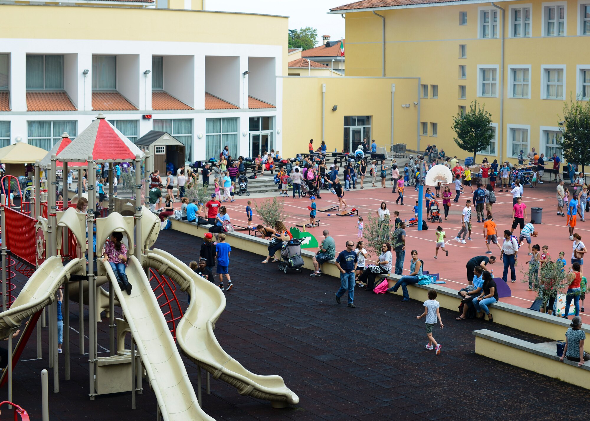 Children, parents and school staff meet during the Back-2-School Bash, Sept. 3, 2015, at Aviano Air Base, Italy. Children participated in different games and activities while parents spoke with teachers and multiple support agencies such as the Airman and Family Readiness Center, Red Cross and Girl Scouts. (U.S. Air Force photo by Senior Airman Austin Harvill/Released)