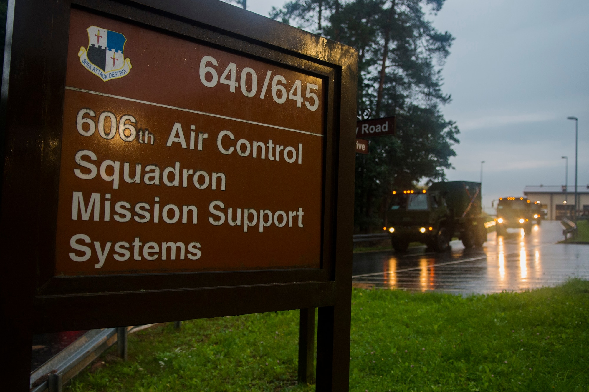 A 606th Air Control Squadron sign stands in front of a traveling U.S. Air Force convoy at Spangdahlem Air Base, Germany, Sep. 1, 2015. The 606th ACS convoy will travel 683 miles to Poland where it will set up two operating bases in Poland working to jointly control airspace. The convoy was the largest to date, consisting of 121 Airmen, 40 vehicles and two TPS-75 radars. (U.S. Air Force photo by Airman 1st Class Luke Kitterman/Released)  