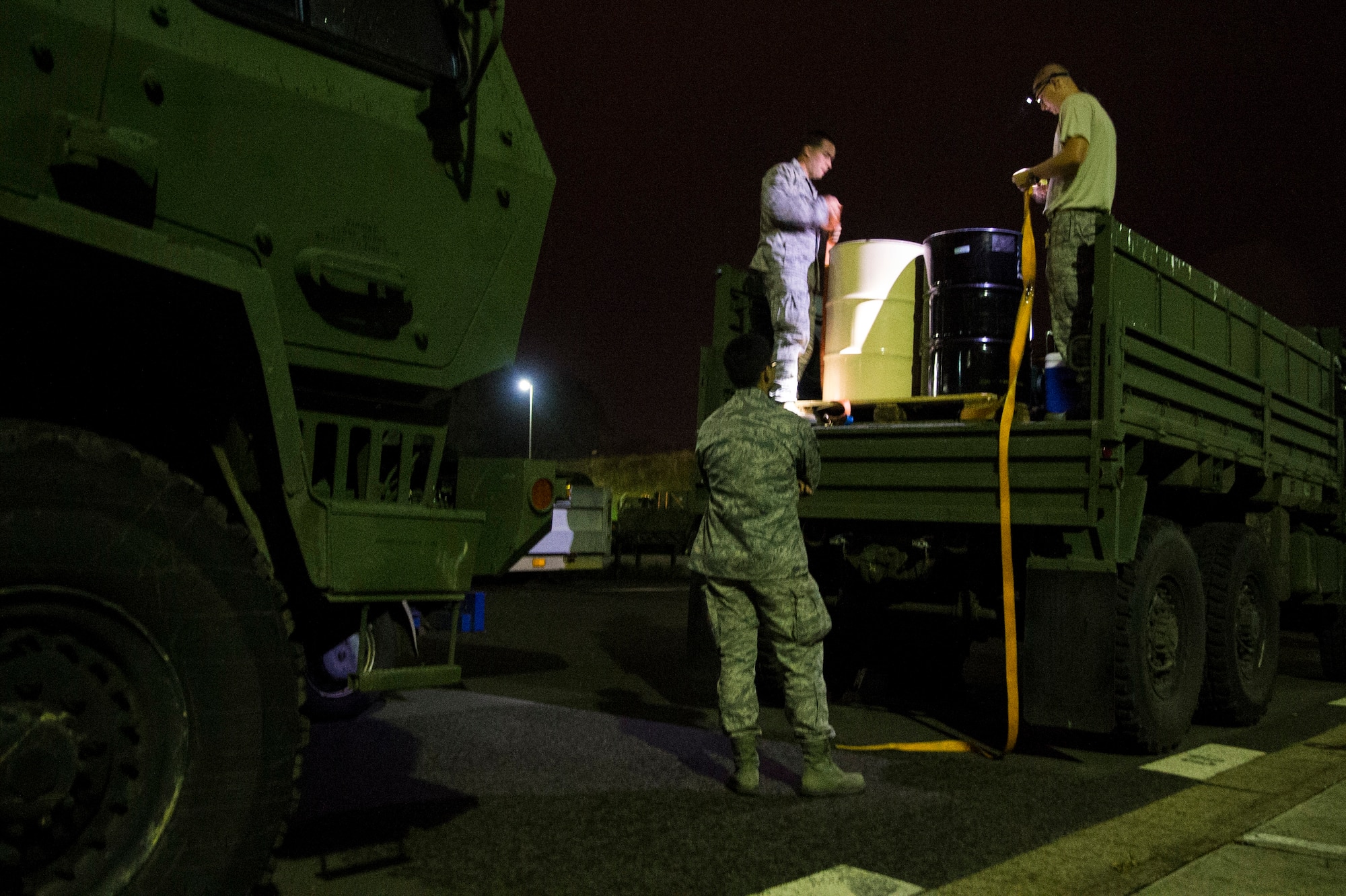 Airmen assigned to the 606th Air Control Squadron prepare a vehicle at Spangdahlem Air Base, Germany, Sep. 1, 2015, before convoying 683 miles to Poland. The convoy was the largest to date, consisting of 121 Airmen, 40 vehicles and two TPS-75 radars. The 606th ACS will set up two operating bases in Poland working to jointly control airspace. (U.S. Air Force photo by Airman 1st Class Luke Kitterman/Released)