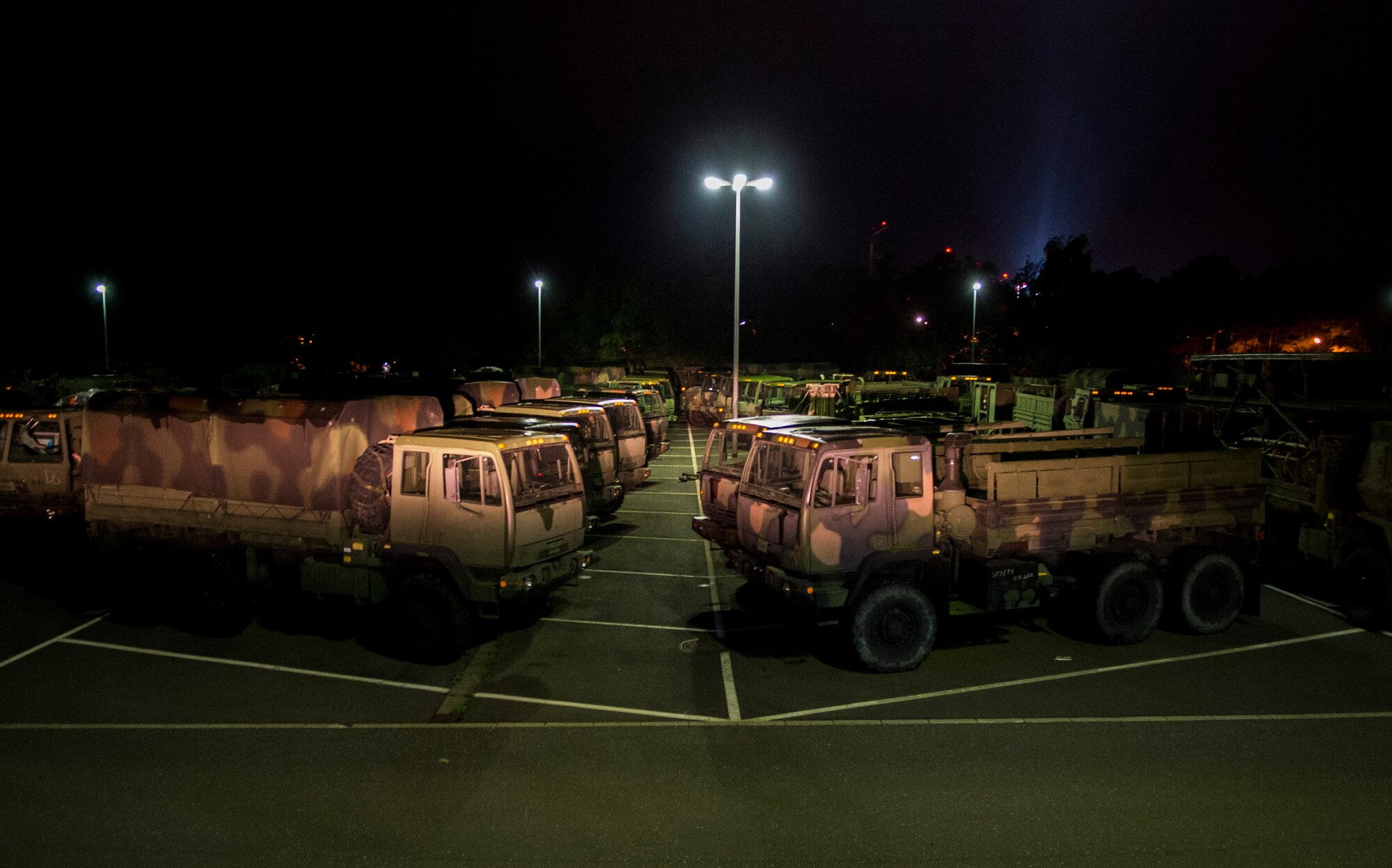 Vehicles assigned to the 606th Air Control Squadron remain parked at Spangdahlem Air Base, Germany, Sep. 1, 2015, before convoying 683 miles to Poland. The convoy was the largest to date, consisting of 121 Airmen, 40 vehicles and two TPS-75 radars. The 606th ACS will set up two operating bases in Poland working to jointly control airspace. (U.S. Air Force photo by Airman 1st Class Luke Kitterman/Released)