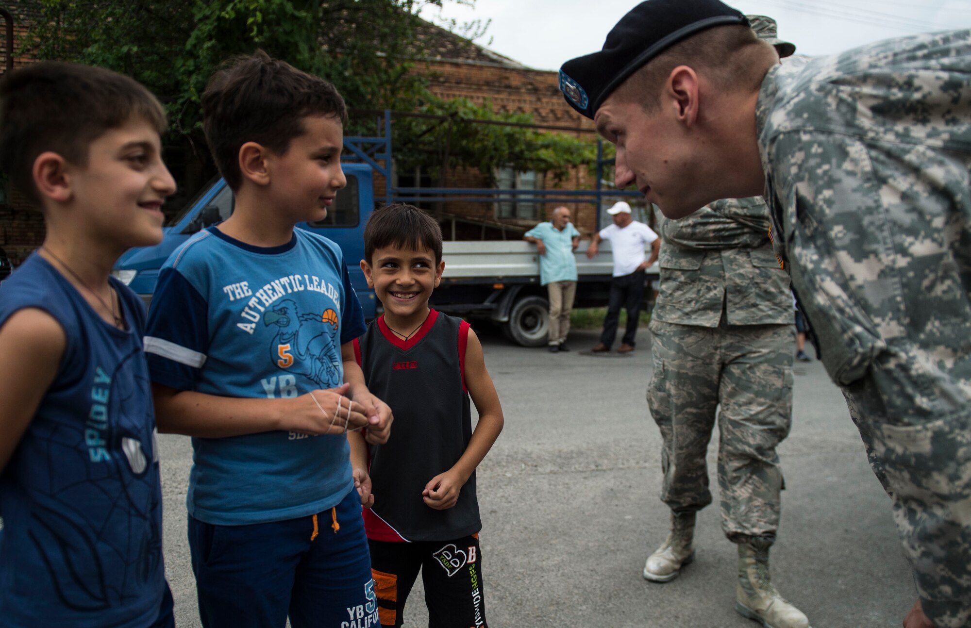 U.S. Army Sgt. Williams Thompson, U.S. Army Europe Civil Affairs specialist from the 457th Civil Affairs Battalion, talks to students during the opening ceremony of Public School No. 4 in Gori, Georgia, Aug. 31, 2015. The ceremony was held as a celebration for the completion of the Georgian Humanitarian and Civic Assistance project led by U.S. European Command. Humanitarian and Civic Assistance projects enhance operational readiness of military personnel while providing mutual support to the host nation's population. (U.S. Air Force photo/Staff Sgt. Sara Keller)