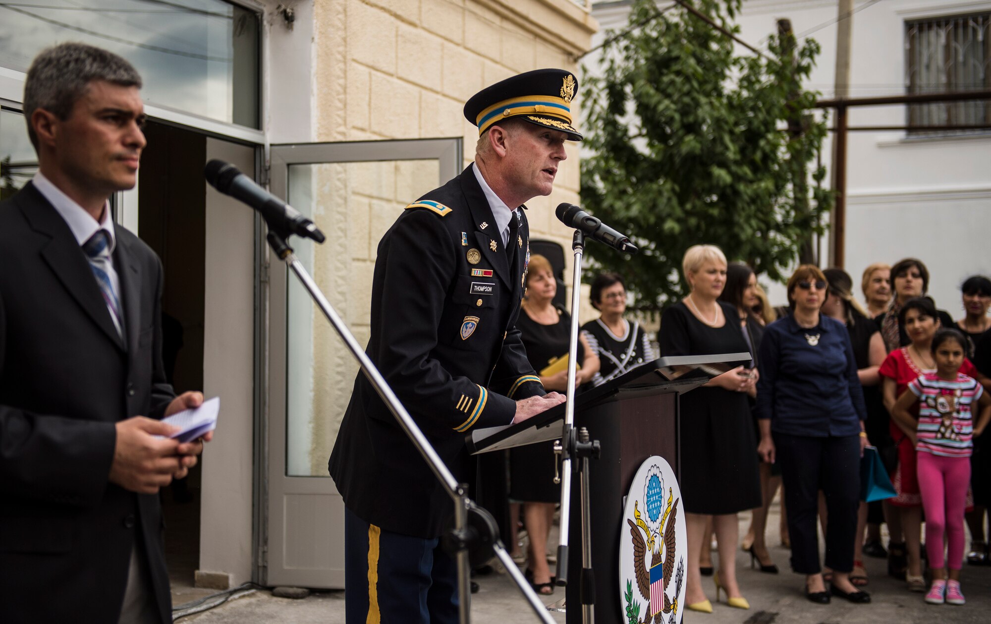 U.S. Army Maj. Colin Thompson, Office of Defense Cooperation Bilateral Affairs Officer, speaks to a group a teachers and community members during the opening ceremony of Public School No. 4 in Gori, Georgia, Aug. 31, 2015. The ceremony was held as a celebration for the completion of the Georgian Humanitarian and Civic Assistance project led by U.S. European Command. Humanitarian and Civic Assistance projects enhance operational readiness of military personnel while providing mutual support to the host nation's population. (U.S. Air Force photo/Staff Sgt. Sara Keller)
