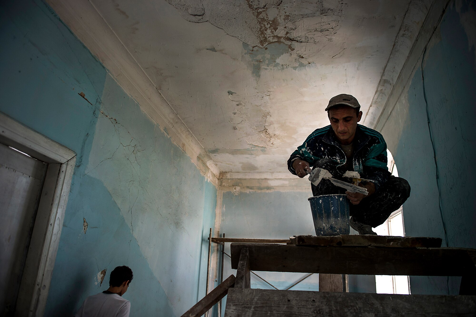 Roin, a Georgian engineer prepares spackle holes in the ceiling of Public School No. 4 in Gori, Georgia, Aug. 27, 2015. Critical areas of the school were renovated by a team of U.S. Air Force engineers, 10 Georgian army engineers, as well as a three-man U.S. Army Europe Civil Affairs team. Humanitarian and Civic Assistance projects enhance operational readiness of military personnel while providing mutual support to the host nation's population. (U.S. Air Force photo/Staff Sgt. Sara Keller)