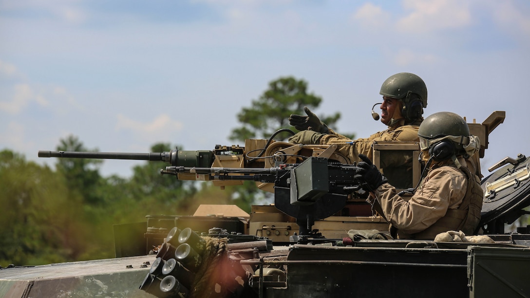Marines with Alpha Company, 2nd Tank Battalion, provide suppressing fire for Marines with Golf Company, 2nd Battalion, 2nd Marine Regiment, during an integrated exercise at Landing Zone Dodo, Camp Lejeune, N.C., Sept. 2, 2015. The tankers provided simulated suppressive fire to support the infantry. 