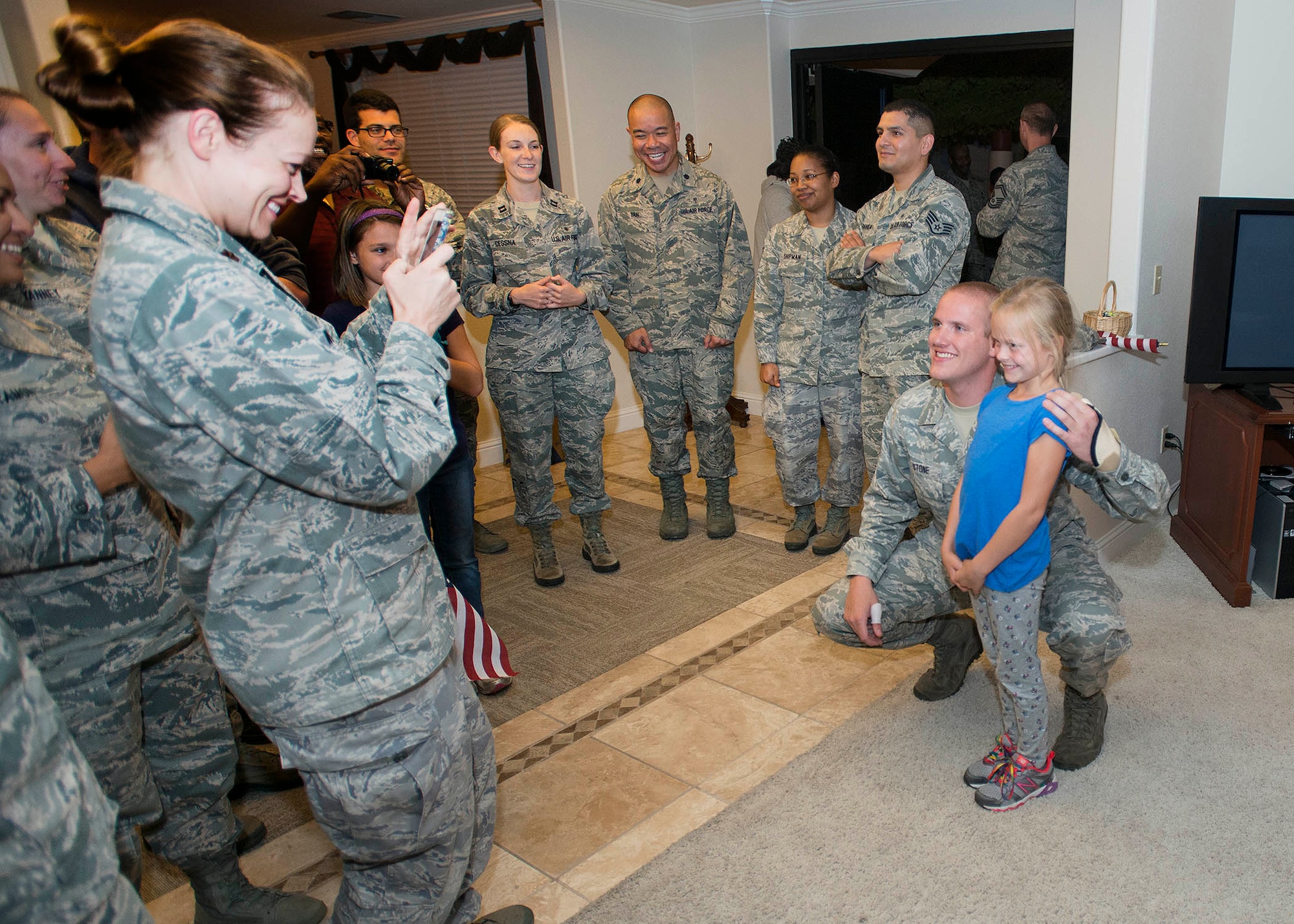 Airman 1st Class Spencer Stone, the Airman who helped foil a terrorist attack on a train in France Aug. 21, poses for photos after arriving at Travis Air Force Base, Calif., Sept. 3, 2015. Stone was greeted by hundreds of Airmen and their families including Col. Joel Jackson, the 60th Air Mobility Wing commander, and Chief Master Sgt. Alan Boling, the 60th AMW command chief. He will receive continued medical treatment for his injuries at David Grant USAF Medical Center. (U.S. Air Force photo/T.C. Perkins)