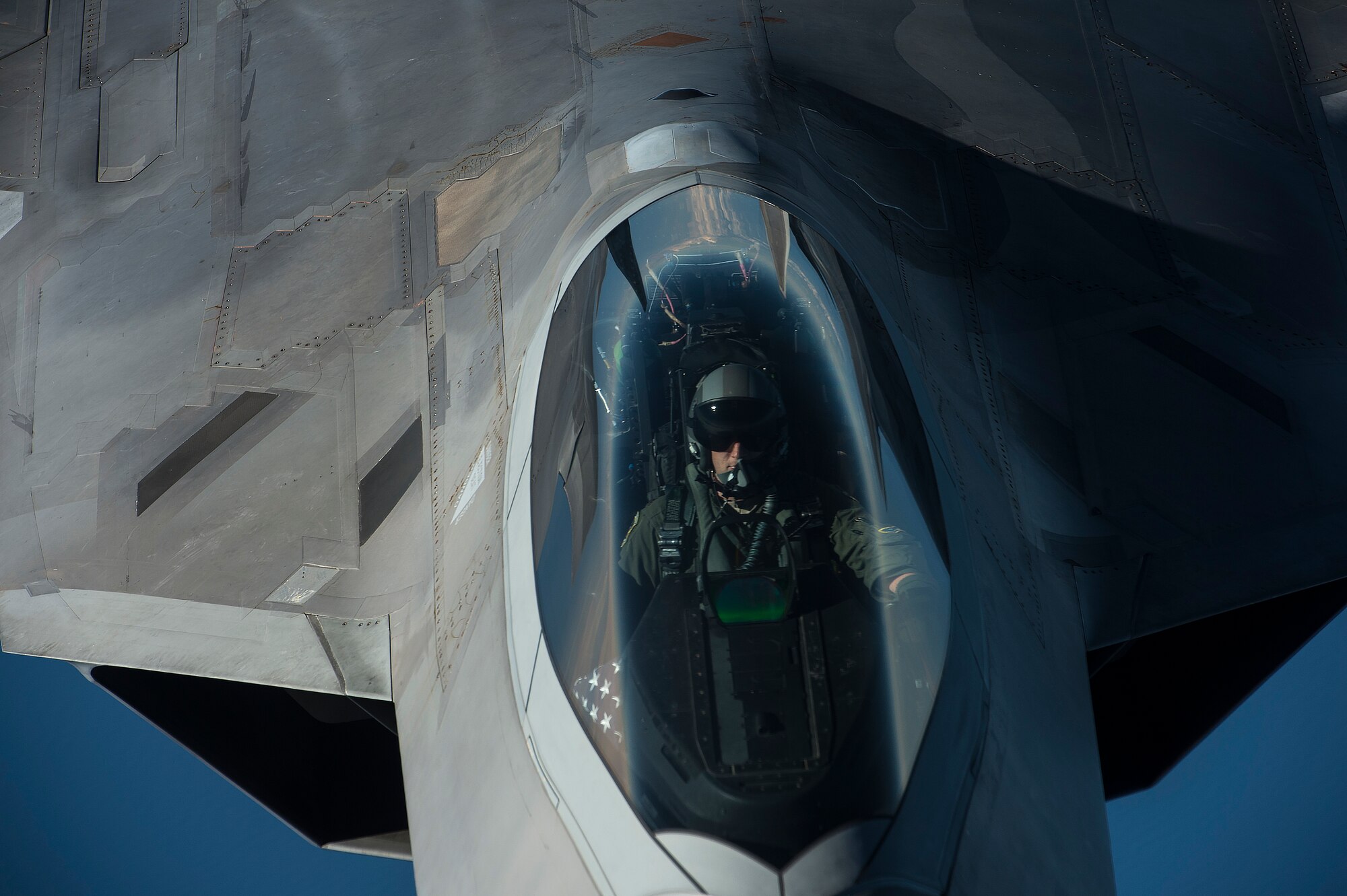 A U.S. Air Force F-22 Raptor pilot from the 95th Fighter Squadron, Tyndall Air Force Base, Fla., flies over the Baltic Sea Sept. 4, 2015. The U.S. Air Force has deployed four F-22 Raptors, one C-17 Globemaster III, approximately 60 Airmen and associated equipment to Spangdahlem Air Base, Germany. While these aircraft and Airmen are in Europe, they will conduct air training with other Europe-based aircraft. (U.S. Air Force photo by Tech. Sgt. Jason Robertson/Released)