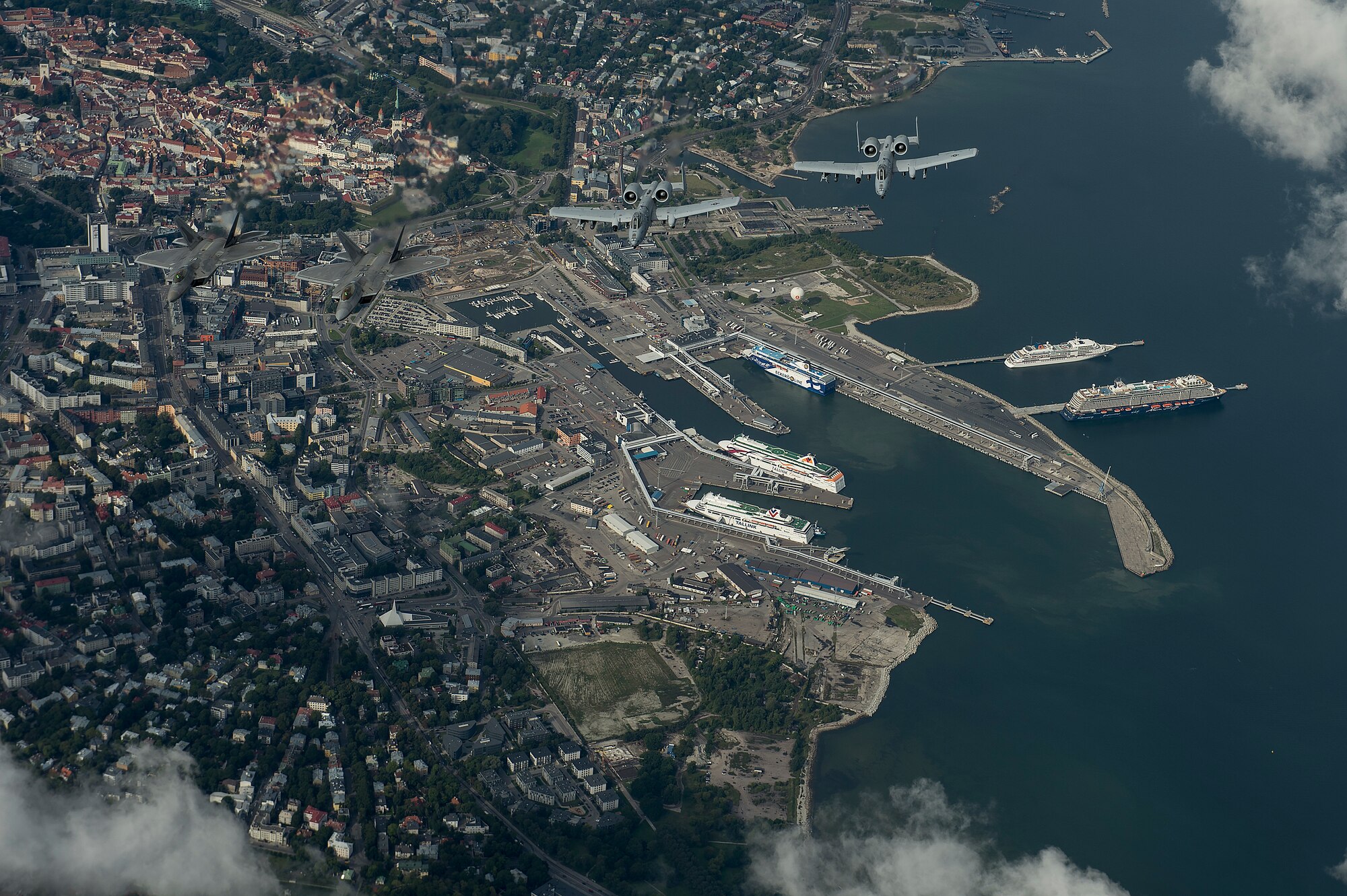 U.S. Air Force F-22 Raptors from the 95th Fighter Squadron, Tyndall Air Force Base, Fla., and A-10 Thunderbolt IIs from the 303rd Fighter Squadron part of the 442nd Fighter Wing, Whiteman Air Force Base, Mo., fly in formation over Tallinn, Estonia, Sept. 4, 2015. The U.S. Air Force has deployed four F-22 Raptors, one C-17 Globemaster III, approximately 60 Airmen and associated equipment to Spangdahlem Air Base, Germany. While these aircraft and Airmen are in Europe, they will conduct air training with other Europe-based aircraft. The United States is committed to ongoing reassurance efforts to NATO allies in Eastern Europe. (U.S. Air Force photo by Tech. Sgt. Jason Robertson/Released)