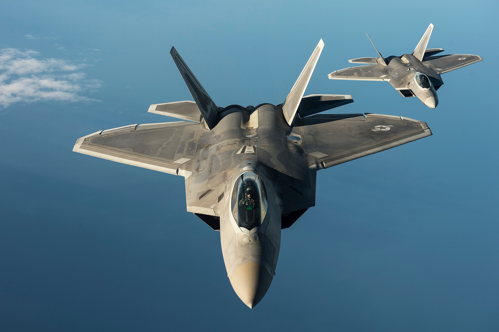 Two U.S. Air Force F-22 Raptors from the 95th Fighter Squadron, Tyndall Air Force Base, Fla., fly over the Baltic Sea, Sept. 4, 2015. The U.S. Air Force has deployed four F-22 Raptors, one C-17 Globemaster III, approximately 60 Airmen and associated equipment to Spangdahlem Air Base, Germany. While these aircraft and Airmen are in Europe, they will conduct air training with other Europe-based aircraft. (U.S. Air Force photo by Tech. Sgt. Jason Robertson/Released)