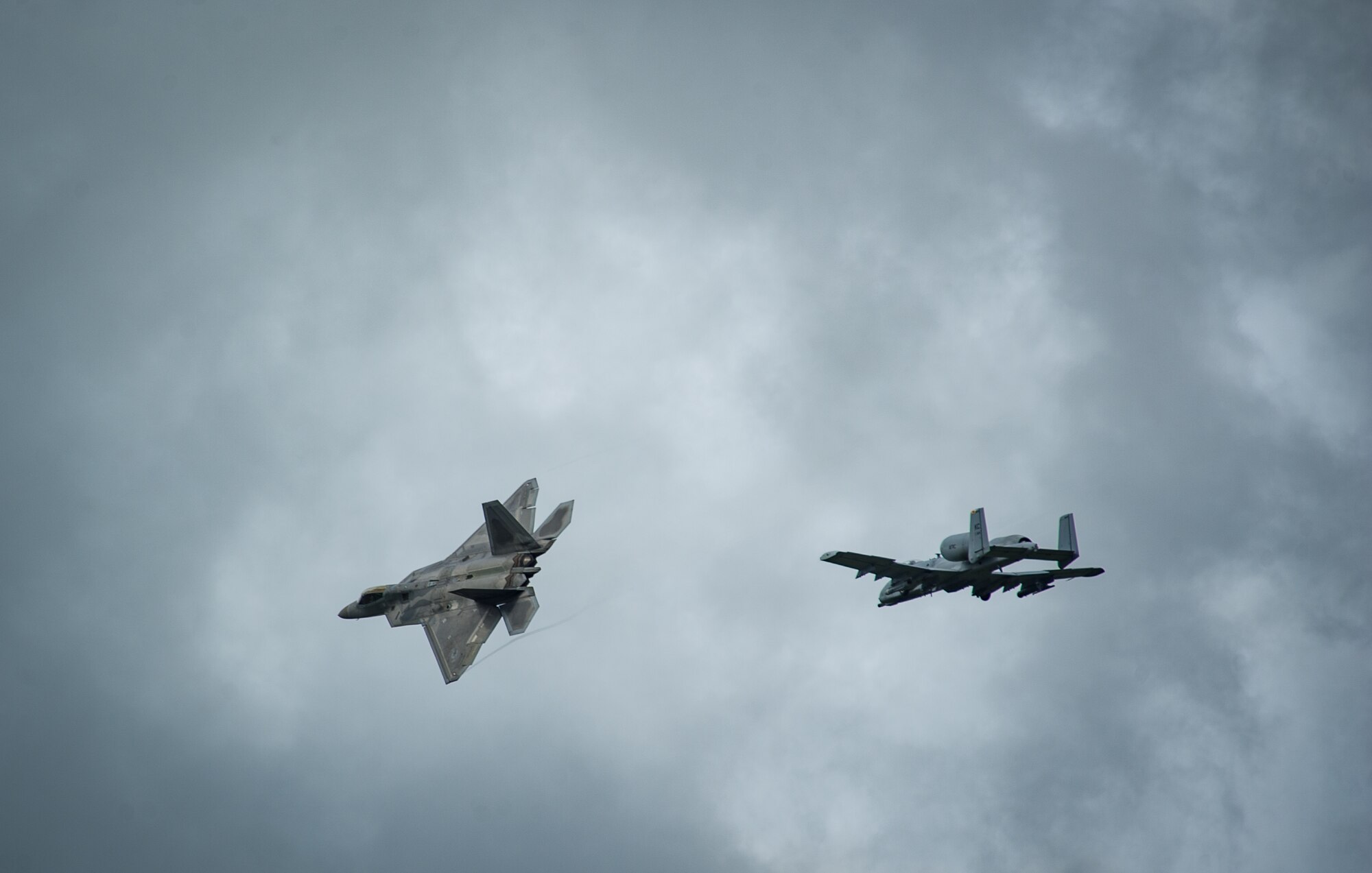 An F-22 Raptor and an A-10 Thunderbolt II fly overhead before landing at ??mari Air Base, Estonia, Sept. 4, 2015, as part of a brief forward deployment. The F-22s have previously deployed to both the Pacific and Southwest Asia for Airmen to train in a realistic environment while testing partner nations' ability to host advanced aircraft like the F-22. The F-22s are deployed from the 95th Fighter Squadron at Tyndall Air Force Base, Florida. The U.S. Air Force routinely deploys aircraft and Airmen to Europe for training and exercises. (U.S. Air Force photo/ Tech. Sgt. Ryan Crane)