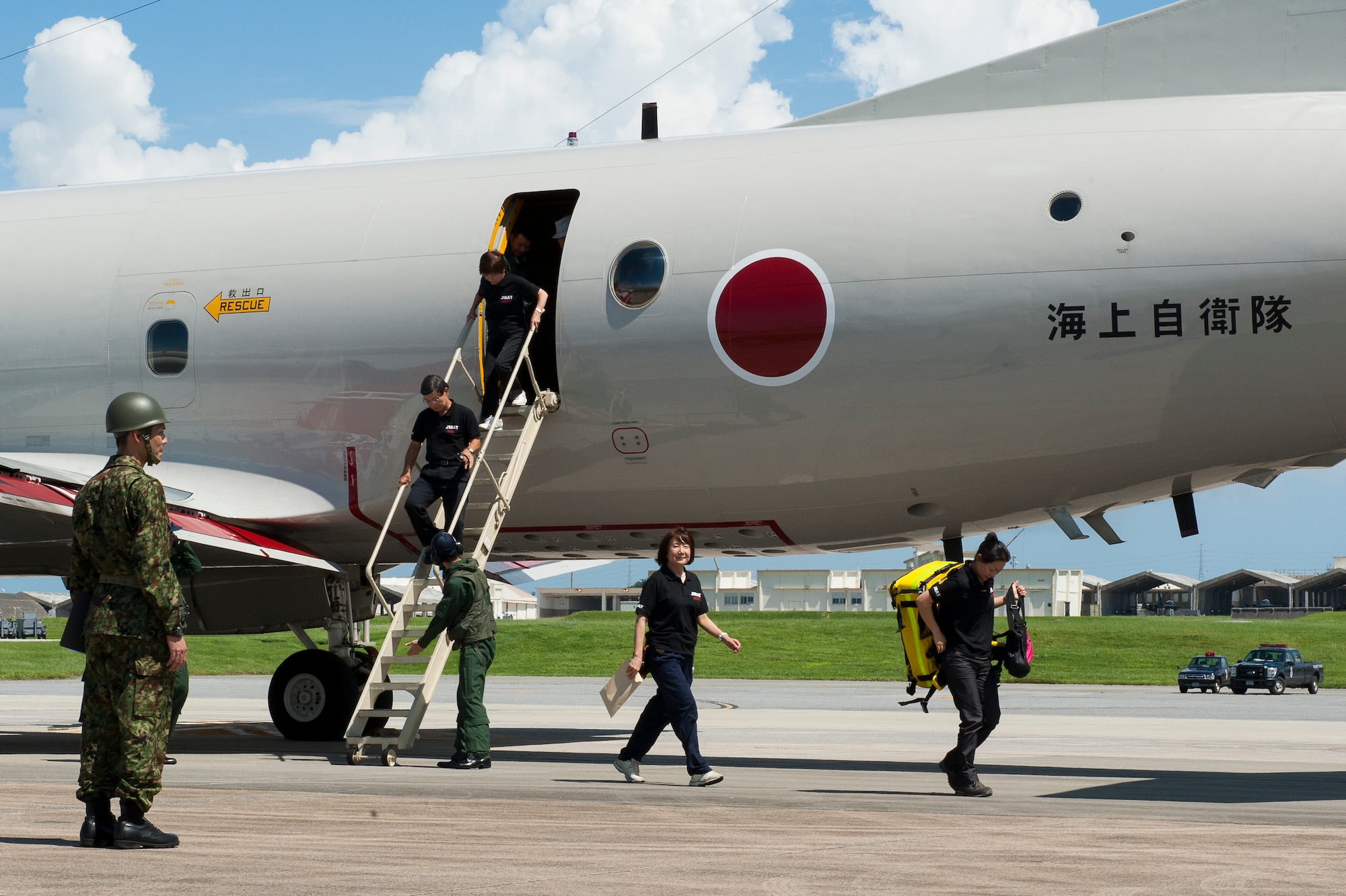 Japanese medical responders arrive on Kadena Air Base, Japan, during a Japanese Air Self-Defense Force ran exercise simulating a natural disaster on the South side of the island, Sept. 5, 2015. The training, which has been conducted several times annually already, has previously involved U.S. Marine Corps personnel and equipment from around the island, but this is the first time Japanese aircraft have used Kadena’s runways as a reception point for JSDF responders from Honshu, or mainland Japan. (U.S. Air Force photo by Airman 1st Class Zackary A. Henry)