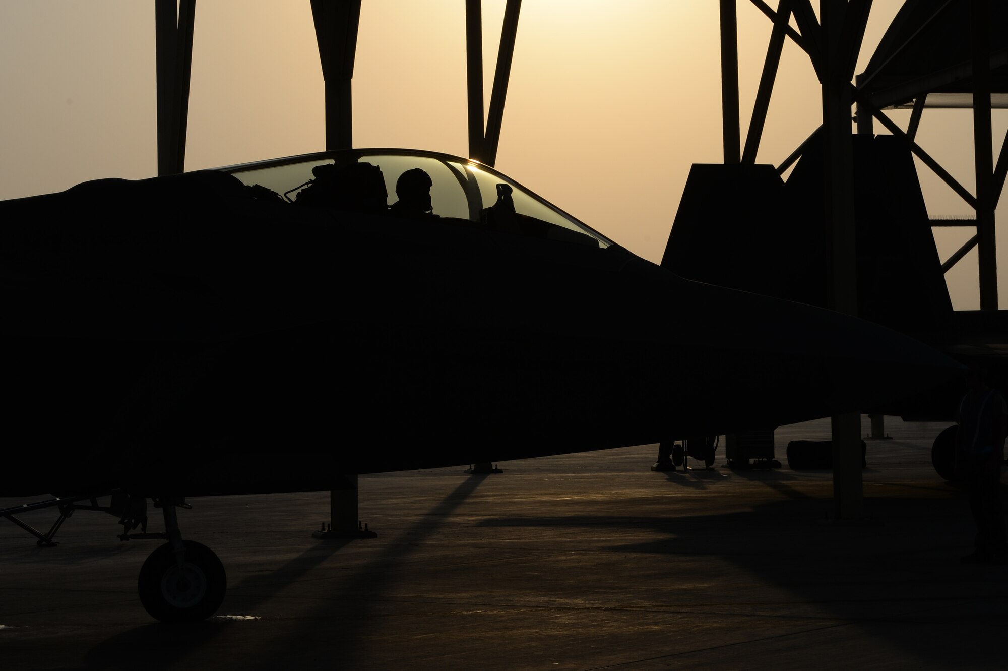 F-22 Raptors prepare to taxi at an undisclosed location in Southwest Asia, August 30, 2015. The F-22’s combination of sensor capability, integrated avionics, situational awareness, and weapons provides first-kill opportunity against threats. (U.S. Air Force photo illustration/ Staff Sgt. Sandra Welch)