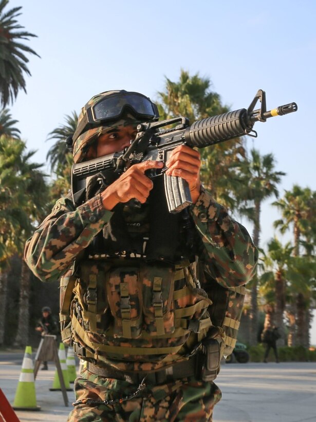 A Marine with Zodiac Battalion, Mexican Naval Infantry Forces, sights down the barrel of his weapon to provide security for his fellow Marines during a patrol on San Onofre beach as part of Exercise Dawn Blitz 2015 aboard Marine Corps Base Camp Pendleton, Calif, Sept. 5, 2015. The purpose of DB15 is to establish strong relationships between coalition forces, to include Japan, Mexico and New Zealand to strengthen operations in joint amphibious environments.
