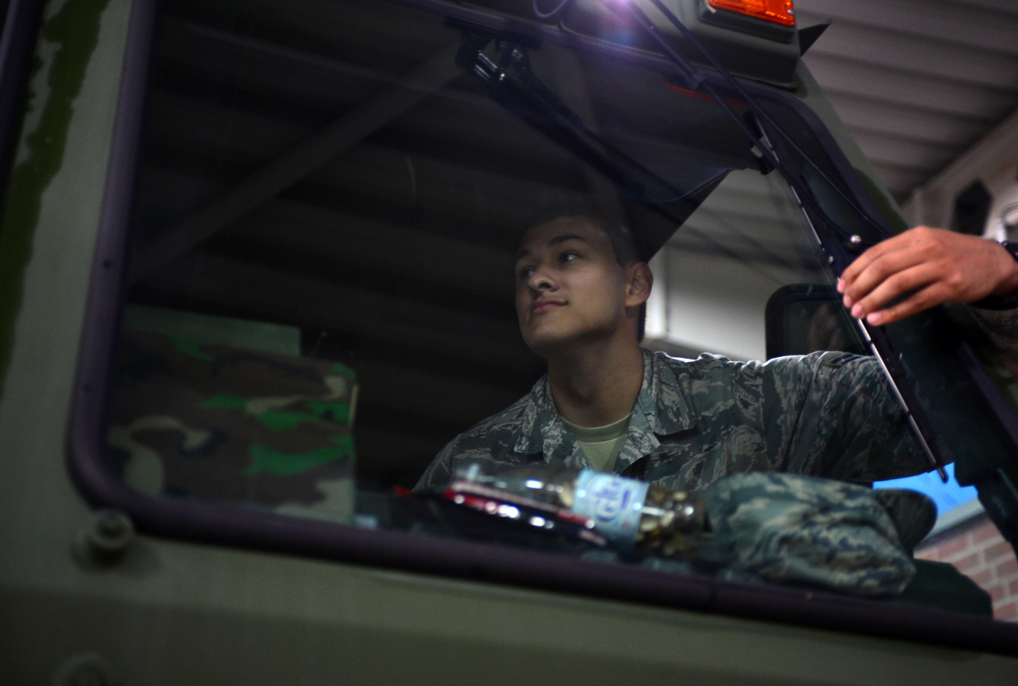 U.S. Air Force Airman 1st Class Anthony Castillo, a 606th Air Control Squadron data maintenance technician, inspects the windshield wipers on a truck during a convoy from Spangdahlem Air Base, Germany, to Poland Sept. 1, 2015. The Airmen made the two day convoy to Krzesiny and Nadarzyce Air Bases, Poland, in advance of Aviation Detachment Rotation 15-4. Hosted by the U.S. Air Force Aviation Detachment station at Łask Air Base, Poland, Av-Det. Rotation 15-4 is the latest training exercise designed to strengthen the interoperability of NATO allies. (U.S. Air Force photo by 2nd Lt. Meredith Mulvihill/Released)