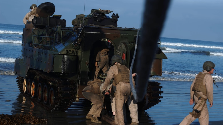 Marines with 3rd Assault Amphibian Battalion unhook towing cables from an amphibious assault vehicle following an amphibious landing during Exercise Dawn Blitz 2015 at Marine Corps Base Camp Pendleton, Calif., Sept. 5, 2015. Dawn Blitz is a multinational, amphibious training exercise designed to hone the amphibious landing skills of I Marine Expeditionary Brigade, Expeditionary Strike Group Three and allies of the United States.