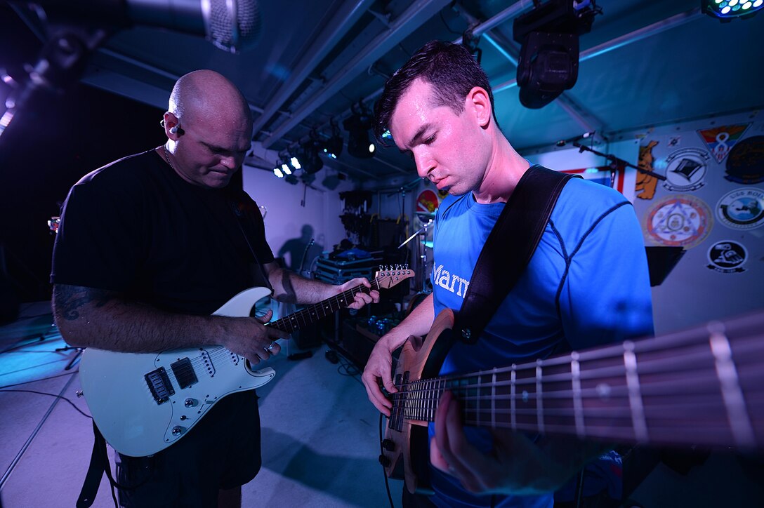 Tech Sgt. Jason Cale and Staff Sgt. Jordan Kimble, Air Forces Central Command band members, entertain service members during a performance at an undisclosed location in Southwest Asia, Aug. 29, 2015. The band uses music as a tool to boost troop morale. (U.S. Air Force photo by Staff Sgt. Emerson Nuñez/Released)
