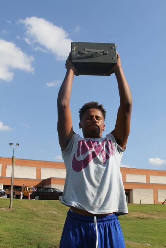 Chance Hagwood, a high school senior and Bassett native, performs the ammo can lift during the Marine Corps Combat Fitness Test, Aug. 27, 2015. The Bassett High School football team took part in the CFT in place of one of their normal practices, giving them a different workout than they are used to and challenging them in ways they’ve never been challenged. (U.S. Marine Corps photo by Sgt. Aaron Diamant/Released)