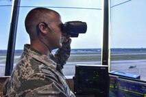 Senior Airman Carmen Simboli, 1st Special Operations Support Squadron air traffic controller, communicates with an inbound aircraft at Hurlburt Field, Fla., August 26, 2015. Air traffic controllers communicate with aircraft crews using a two-way radio system. (U.S. Air Force photo/Senior Airman Jeff Parkinson)