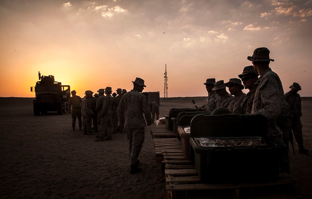 KUWAIT (Aug. 17, 2015) U.S. Marines with Lima Company, Battalion Landing Team 3rd Battalion, 1st Marine Regiment, 15th Marine Expeditionary Unit, enjoy hot chow while in the field. Elements of the 15th MEU are ashore in Kuwait for sustainment training to maintain and enhance the skills they developed during their pre-deployment training period.  The 15th MEU is embarked with the Essex Amphibious Ready Group and deployed to maintain regional security in the U.S. 5th Fleet area of operations. (U.S. Marine Corps photo by Cpl. Elize McKelvey/Released)