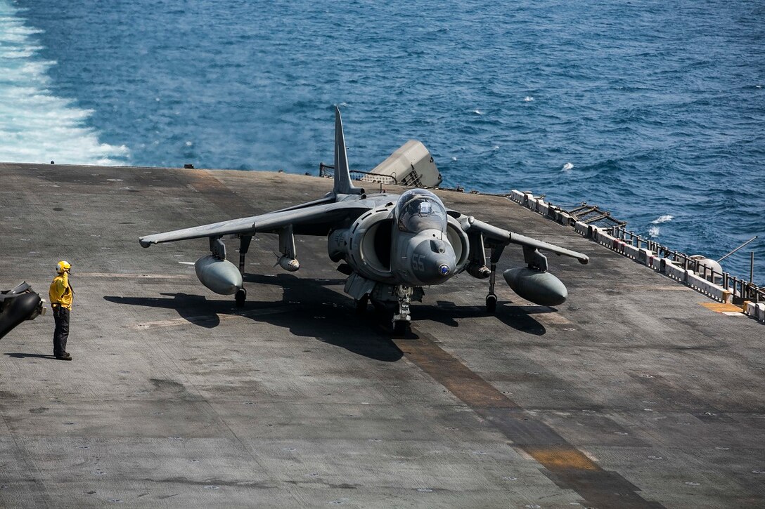 An AV-8B Harrier with Medium Marine Tiltrotor Squadron 161 (Reinforced), 15th Marine Expeditionary Unit, prepares to depart the amphibious assault ship USS Essex (LHD 2) in order to support Operation Inherent Resolve. U.S. Marines and Sailors aboard Essex work side-by-side to ensure mission success. The 15th MEU is embarked on the Essex Amphibious Ready Group and are deployed to maintain regional security in the U.S. 5th Fleet area of operations. (U.S. Marine Corps photo by Cpl. Anna Albrecht/Released)