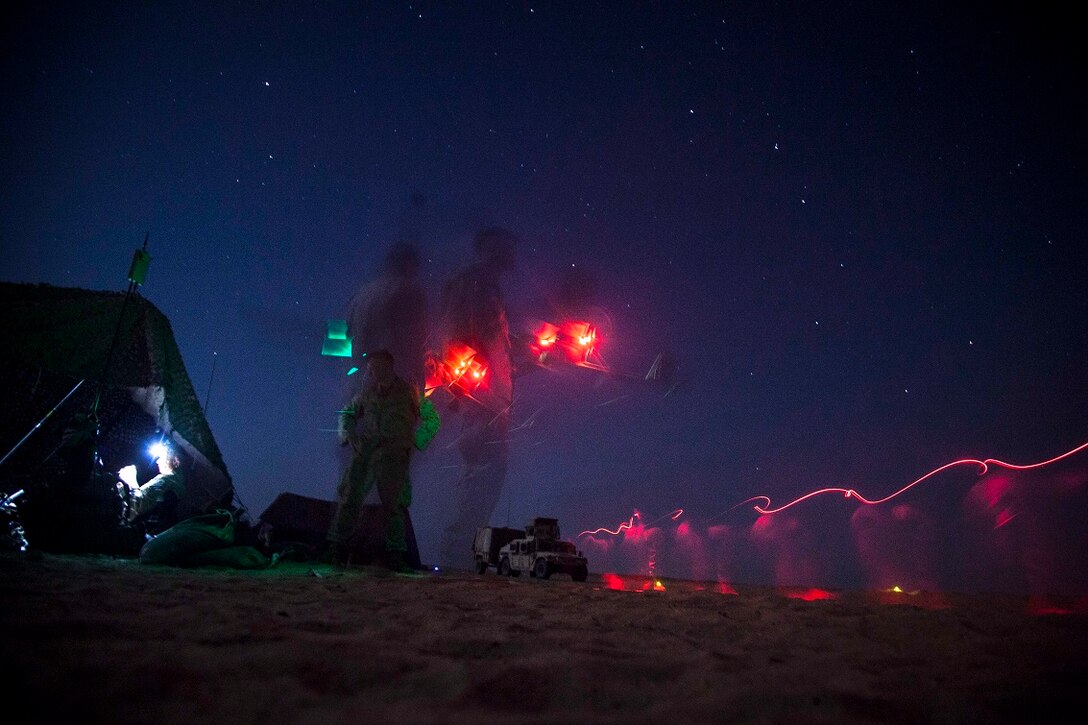 KUWAIT (Aug. 23, 2015) A U.S. Marine with Lima Company, Battalion Landing Team 3rd Battalion, 1st Marine Regiment, 15th Marine Expeditionary Unit, prepares to launch an RQ-11 Raven during a training exercise. The Raven is a small, hand-launched, remote-controlled, unmanned aerial vehicle that has day and night aerial intelligence, surveillance, target acquisition, and reconnaissance capabilities. Elements of the 15th MEU are ashore in Kuwait for sustainment training to maintain and enhance the skills they developed during their pre-deployment training period.  The 15th MEU is embarked with the Essex Amphibious Ready Group and deployed to maintain regional security in the U.S. 5th Fleet area of operations. (U.S. Marine Corps photo by Cpl. Elize McKelvey/Released)