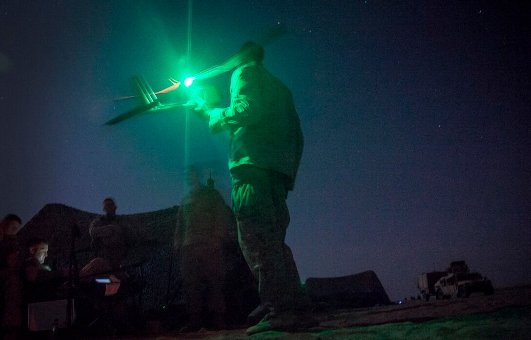 KUWAIT (Aug. 23, 2015) U.S. Marines with Lima Company, Battalion Landing Team 3rd Battalion, 1st Marine Regiment, 15th Marine Expeditionary Unit, prepare to launch an RQ-11 Raven during a training exercise. The Raven is a small, hand-launched, remote-controlled, unmanned aerial vehicle that has day and night aerial intelligence, surveillance, target acquisition, and reconnaissance capabilities. Elements of the 15th MEU are ashore in Kuwait for sustainment training to maintain and enhance the skills they developed during their pre-deployment training period.  The 15th MEU is embarked with the Essex Amphibious Ready Group and deployed to maintain regional security in the U.S. 5th Fleet area of operations. (U.S. Marine Corps photo by Cpl. Elize McKelvey/Released)