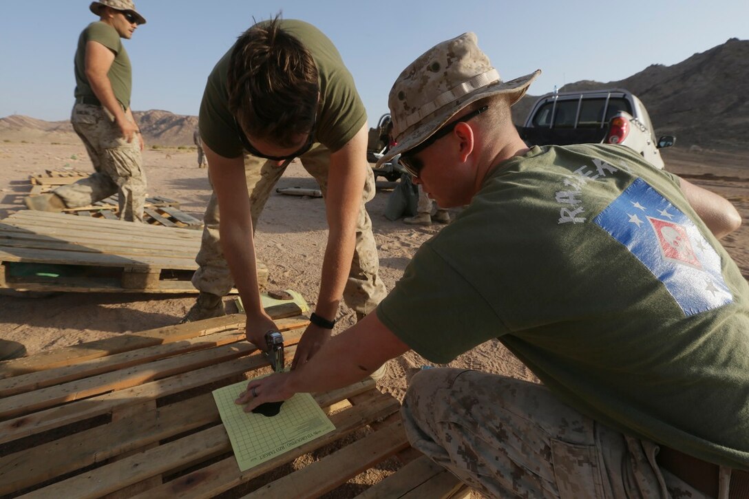 Southwest Asia (Aug. 23, 2015)  U.S. Marine Lance Cpls. Nickolaus Brown, right, and James White build targets while setting up a live-fire range. Brown and White are riflemen with India Company, Battalion Landing Team 3rd Battalion, 1st Marine Regiment, 15th Marine Expeditionary Unit. The 15th MEU is deployed throughout Southwest Asia to maintain regional security in the U.S. 5th Fleet area of operations.  The 15th MEU provides flexible, responsive options across the range of military operations to support regional security in the U.S. 5th Fleet AOR. (U.S. Marine Corps photo by Sgt. Jamean Berry/Released)