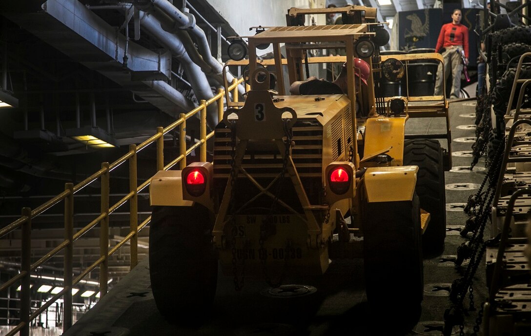 ARABIAN GULF (Sept. 3, 2015) U.S. Sailors with the Essex Amphibious Ready Group move gear around to make room in the hangar bay of the amphibious assault ship USS Essex (LHD 2). The 15th MEU is embarked aboard the Essex Amphibious Ready Group and deployed to maintain regional security in the U.S. 5th Fleet area of operations. (U.S. Marine Corps photo by Cpl. Elize McKelvey/Released)