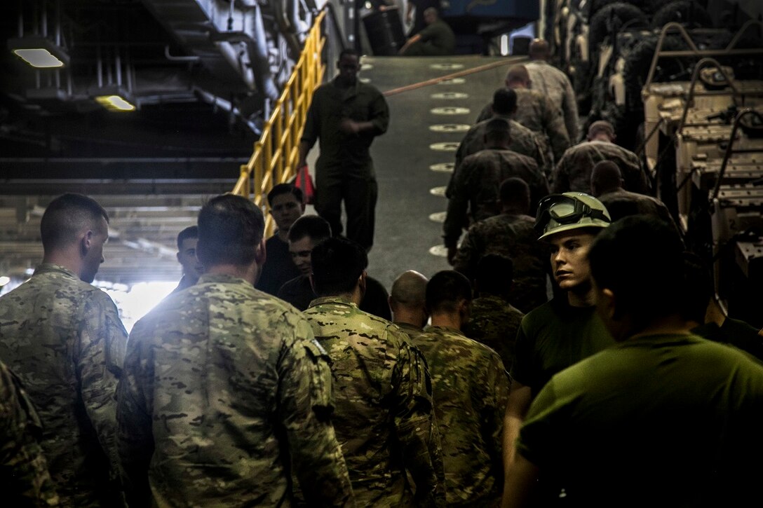 ARABIAN GULF (Sept. 3, 2015) U.S. Soldiers with the 1-66th Armor Regiment begin a tour aboard the amphibious assault ship USS Essex (LHD 2). The Soldiers are stationed out of Bahrain. The 15th MEU is embarked with the Essex Amphibious Ready Group and are deployed to maintain regional security in the U.S. 5th Fleet area of operations. (U.S. Marine Corps photo by Cpl. Elize McKelvey/Released)