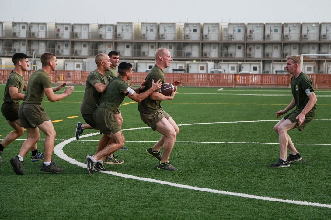 CAMP LEMONNIER, Djibouti (Sept. 4, 2015) U.S. Marine Gunnery Sgt. Karl Warnstedt, right, prepares to block Cpl. Craig Herman as he goes in for a touchdown during unit physical training. Warnstedt is the fire support chief for Battalion Landing Team 3rd  Battalion, 1st  Marine Regiment, 15th Marine Expeditionary Unit. Elements of the 15th MEU are preparing to conduct bilateral training with the 5th Overseas Combined Arms Regiment (RIAOM) in Djibouti in order to improve interoperability between the MEU and the French military. (U.S. Marine Corps photo by Sgt. Steve H. Lopez/Released)