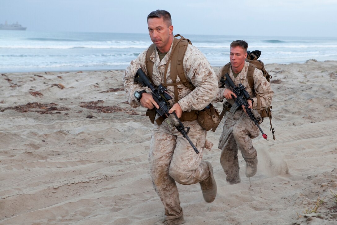 Marines run to secure the beach during an amphibious landing as they participate in Exercise Dawn Blitz 2015 on Camp Pendelton, Calif., Sept. 5, 2015. The scenario-driven exercise trains the U.S. Navy and Marine Corps in amphibious task force operations while building U.S. and coalition operational interoperability. U.S. Navy photo by Petty Officer 2nd Class Ryan Riley
