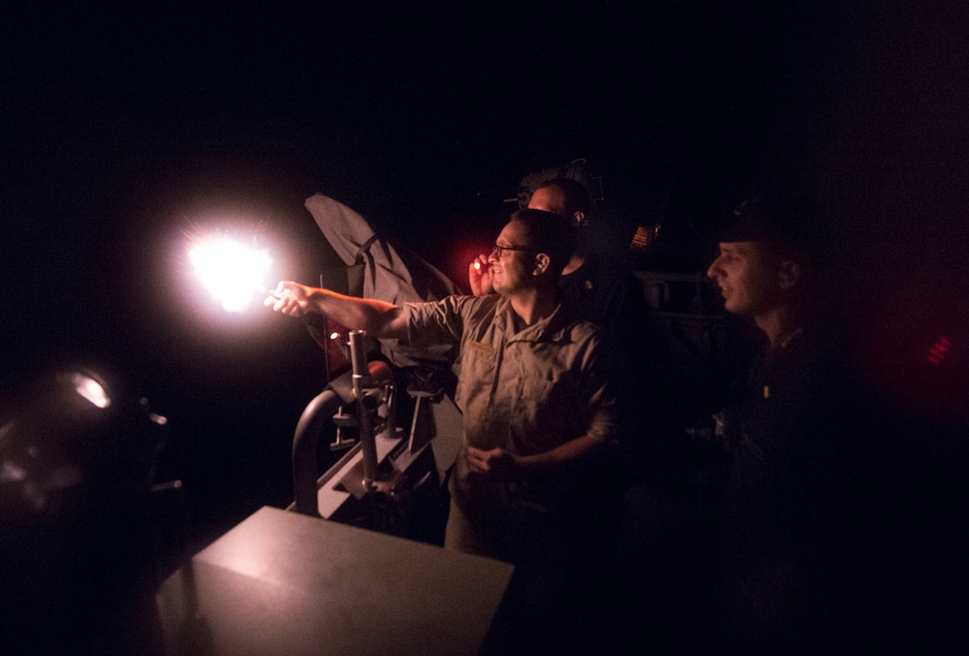 U.S. Navy Chief Petty Officer William Garcia fires an illumination round from the bridge wing of the littoral combat ship USS Fort Worth during a training exercise in the South China Sea, Sept. 6, 2015. The USS Fort Worth is on a 16-month rotational deployment supporting the Indo-Asia-Pacific rebalance. Garcia is a boatswain’s mate. U.S. Navy photo by Petty Officer 2nd Class Joe Bishop