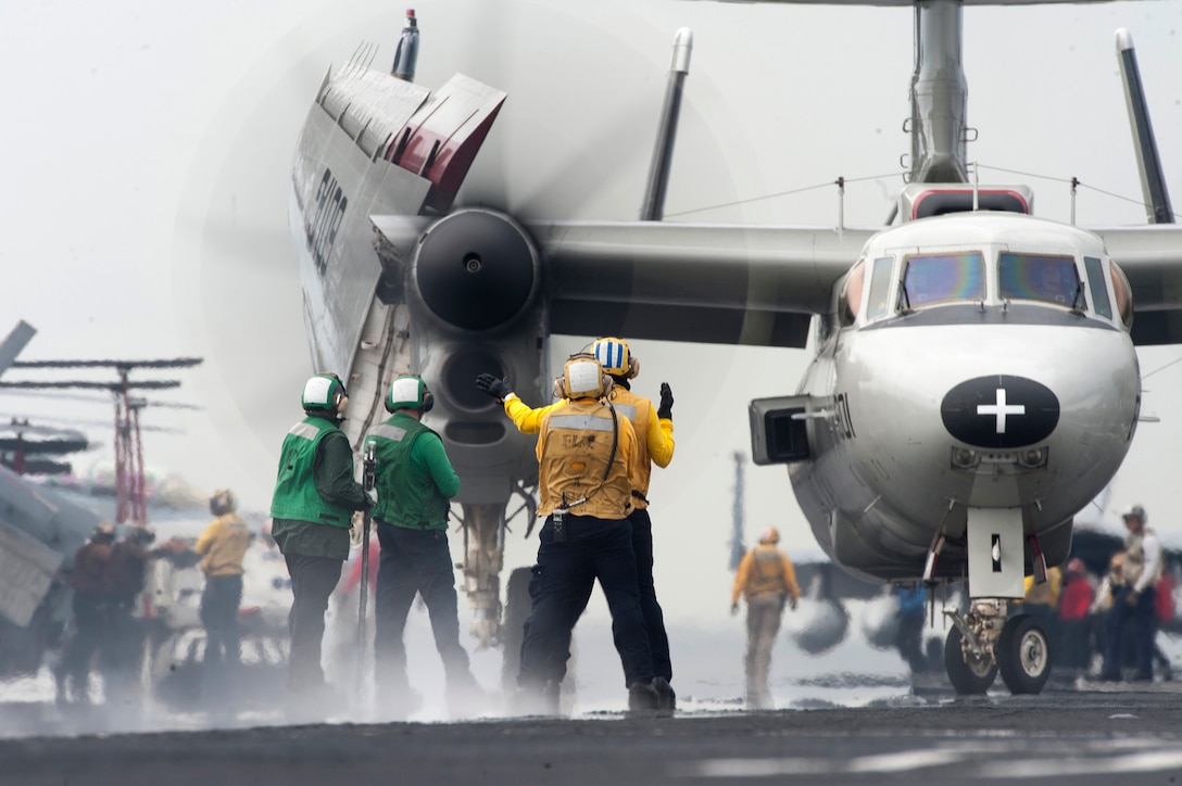 U.S. sailors direct an E-2C Hawkeye on the flight deck of the aircraft carrier USS Harry S. Truman in the Atlantic Ocean, Sept. 6, 2015, as they train for deployment. The Hawkeye is assigned to the Carrier Early Warning Squadron 117. U.S. Navy photo by Petty Officer 3rd Class L. C. Edwards